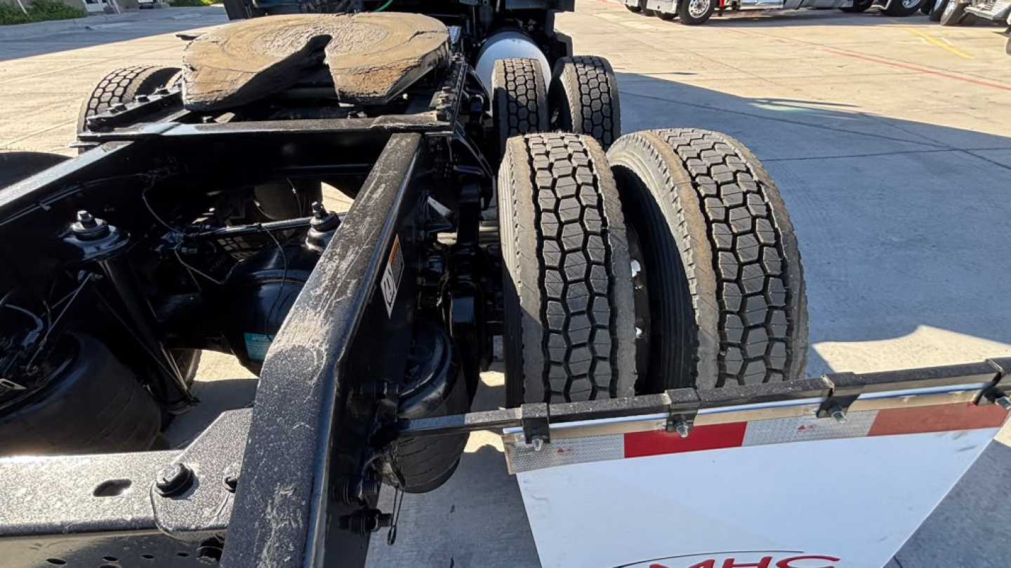 Kenworth T680 truck chassis with dual rear wheels and exposed frame, rear view showing tires and undercarriage, VIN/stock not visible in this shot
