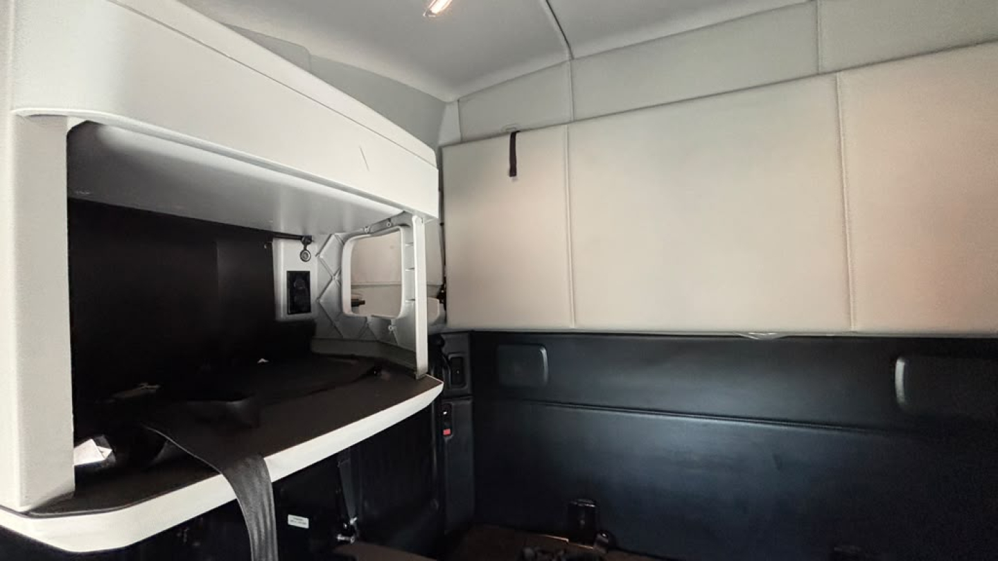 Kenworth T680 sleeper cab interior showing side panel and storage area.