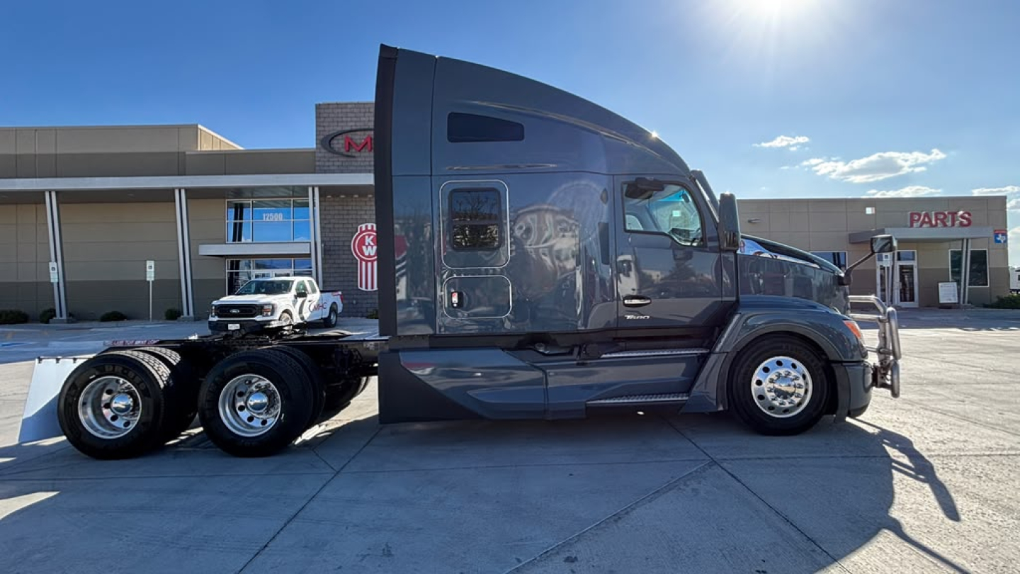 Kenworth T680 semi-truck side view showing sleeper cab and chassis with dual rear axles.