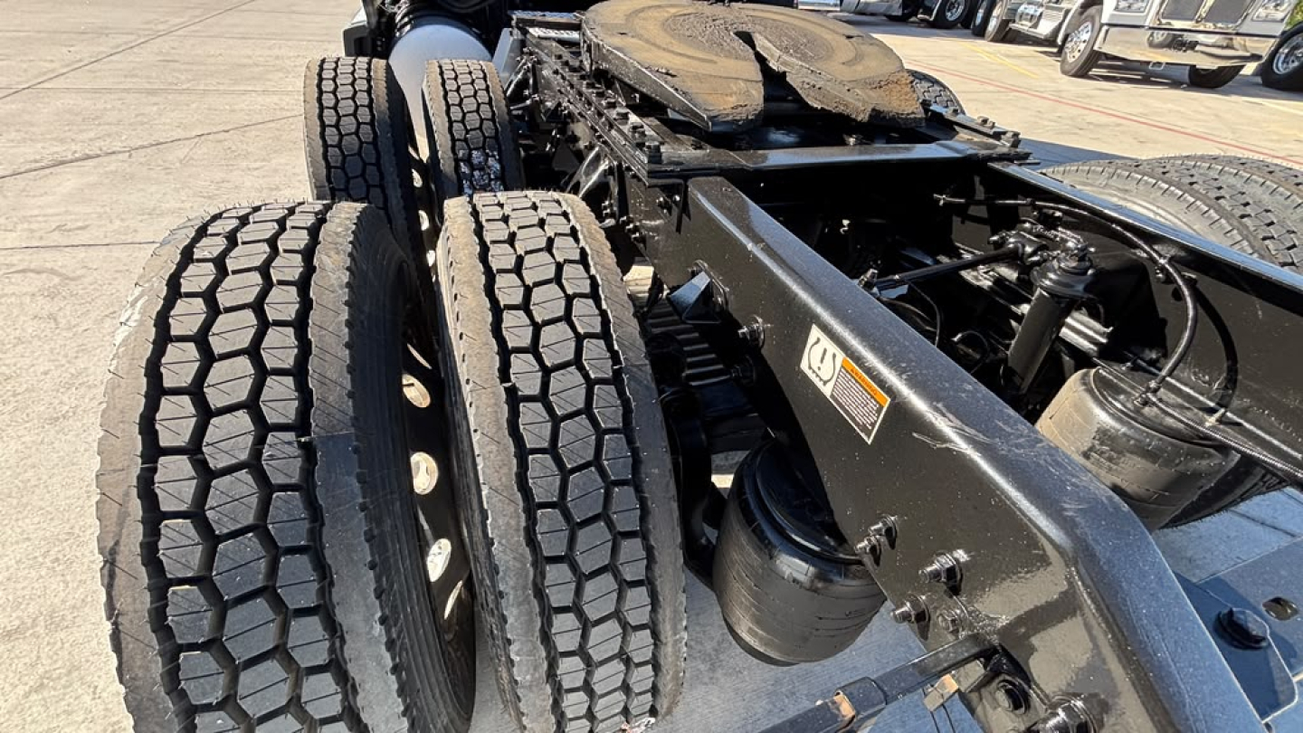Kenworth T680 truck chassis with dual rear axles and tire treads visible, frame and suspension components in view
