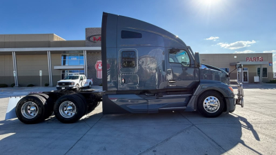 Kenworth T680 semi-truck side view showing sleeper cab and chassis with dual rear axles.