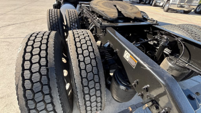 Kenworth T680 truck chassis with dual rear axles and tire treads visible, frame and suspension components in view