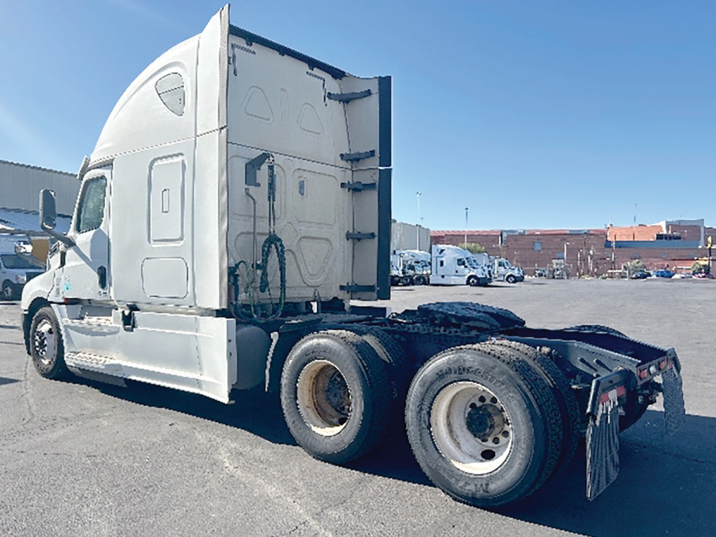 Truck side view showing Freightliner Cascadia 126 sleeper cab, dual rear axles, white paint, no visible branding other than standard cab design, VIN/stock not shown on image