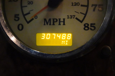 Dashboard meter showing mph scale and yellow digital odometer reading 307488 miles.