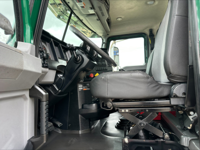 Cab interior of a 2020 Mack PI64T daycab showing driver seat and dashboard with steering wheel and control stalks.