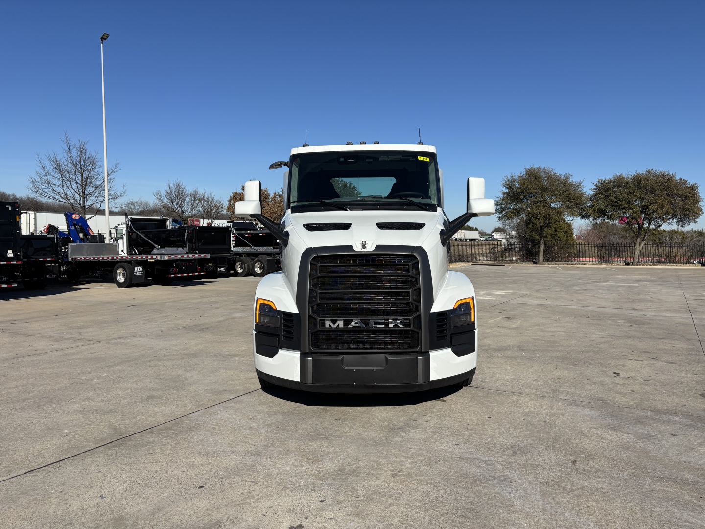 Front view of a white 2027 Mack PR64T conventional daycab truck showing grille, headlights, and large bumper.
