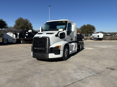 Truck front-left view of a white 2027 Mack PR64T conventional daycab showing Mack grille and headlights.