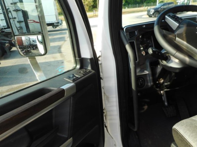 Truck cab interior showing steering wheel and driver door window controls in a Western Star 47X cab.