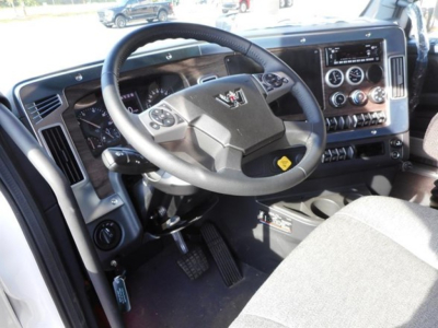 Truck interior showing steering wheel, dashboard with gauges, and center console of a Western Star 47X cab.