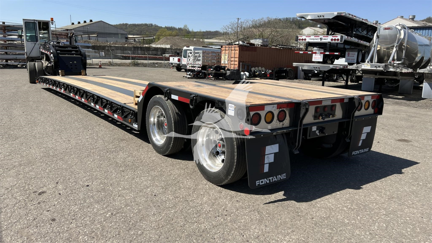 Fontaine XN20 lowboy trailer showing wooden deck, dual rear axles, and rear bumper with taillights and Fontaine branding