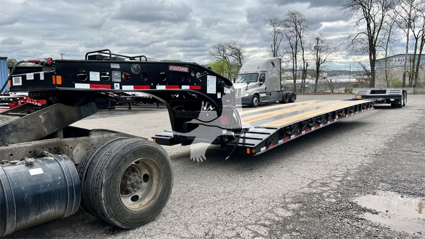 Lowboy trailer showing Fontaine XN20 with long flatbed and undercarriage, wheel, and hitch visible.