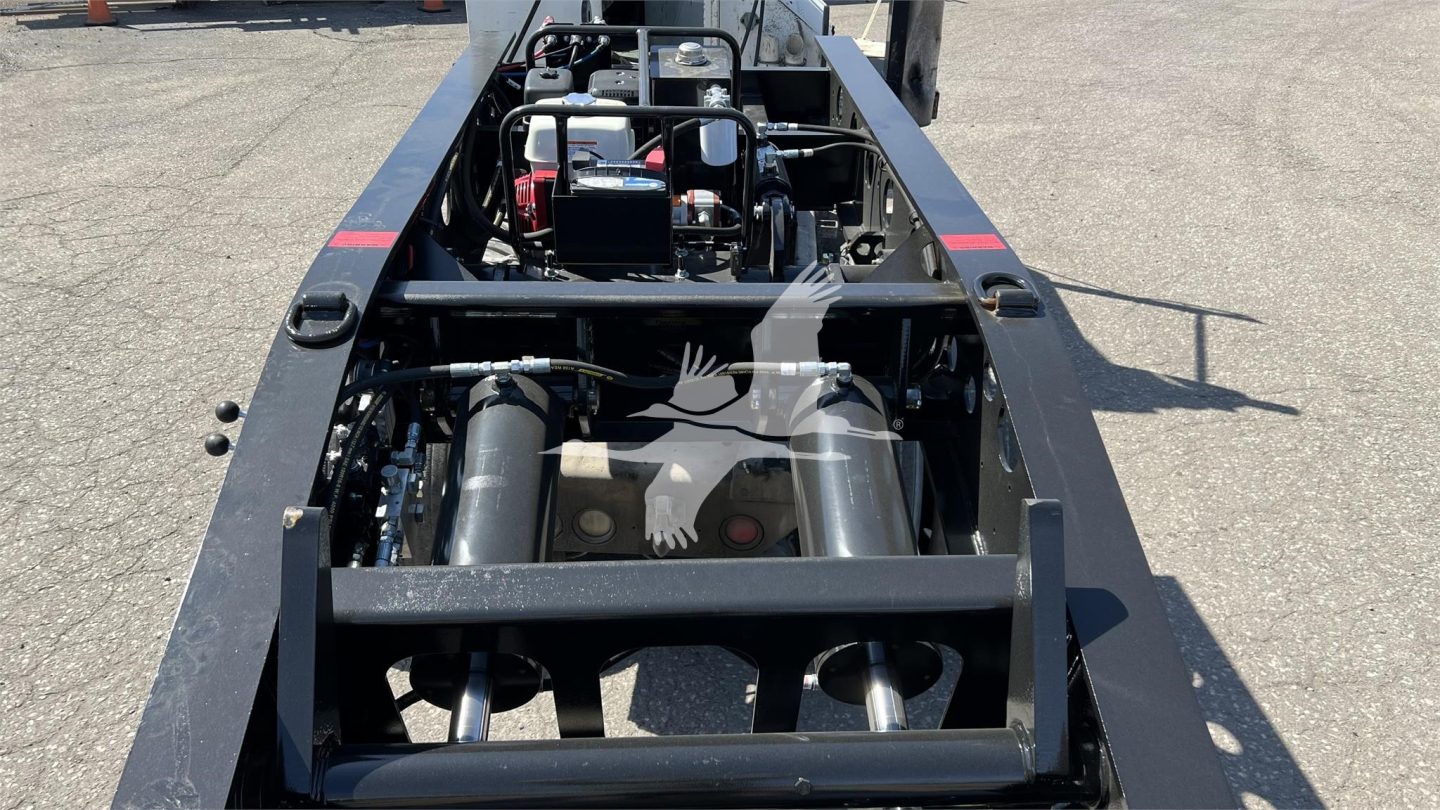 Trailer frame and machinery view showing hydraulic components and dual air tanks labeled Fontaine XN20 lowboy trailer undercarriage.