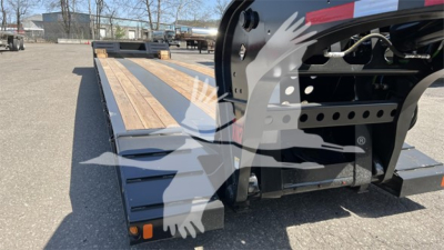 Fontaine Renegade Xn20 lowboy trailer with wooden deck and hydraulic neck, side rails, and hitch area visible.