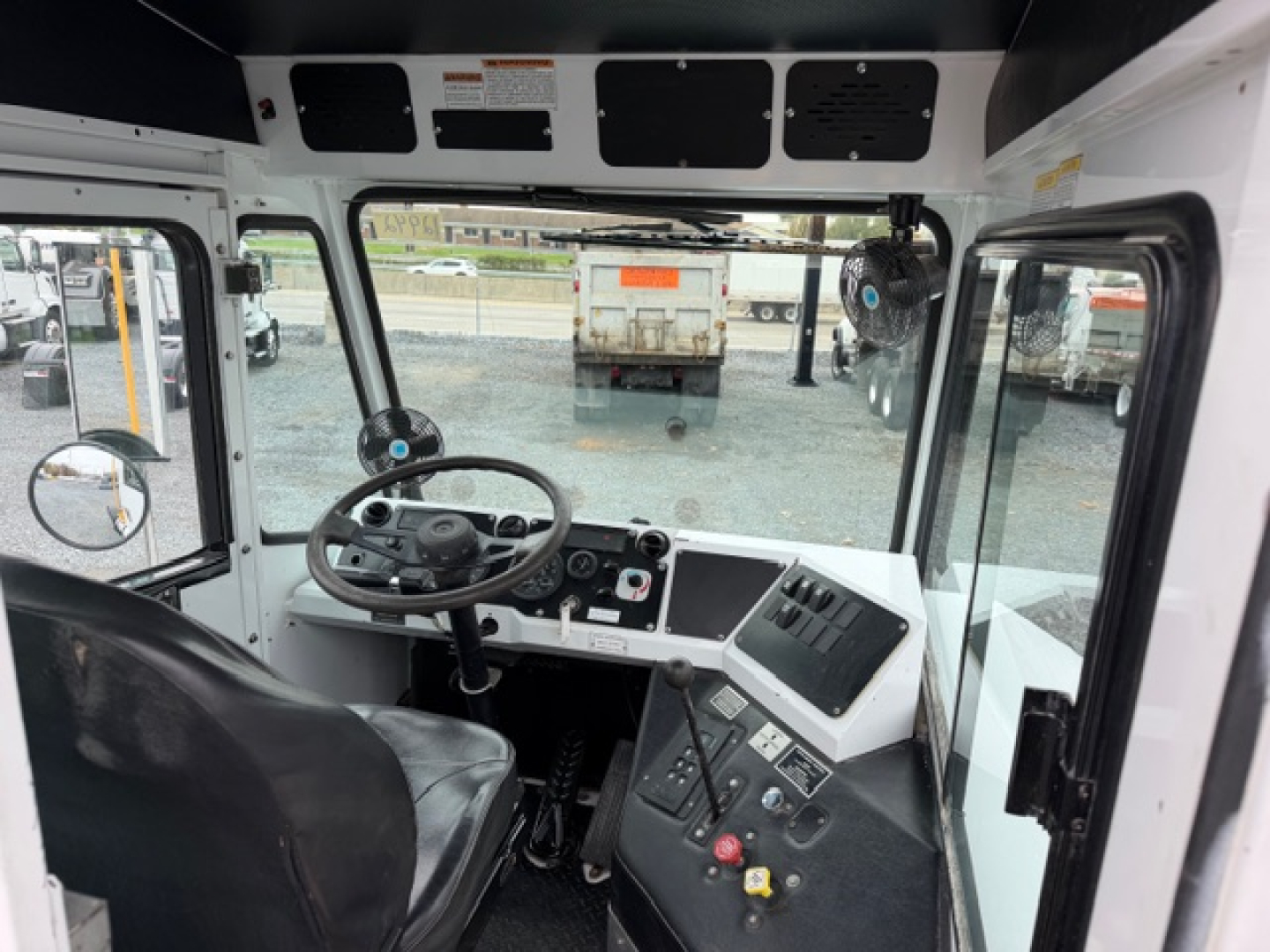 Cable-operated control cabin of a 2021 Capacity TJ5000 truck showing dashboard, steering wheel, and instrument panel from the driver's seat view.