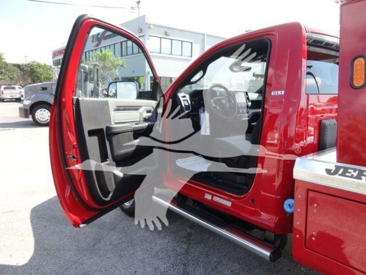 Ram 4500 interior view with front passenger door open, red pickup with winch category; dashboard and steering wheel visible.