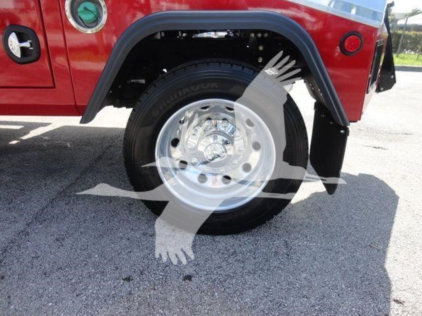 Ram 4500 front wheel and fender area showing chrome wheel, black tire, red body panel, and fender flare with brand markings.