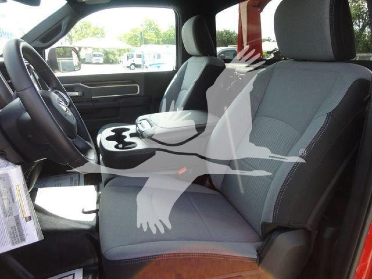 Ram 4500 interior showing front seats and center console; grey cloth seats; part of dashboard visible.