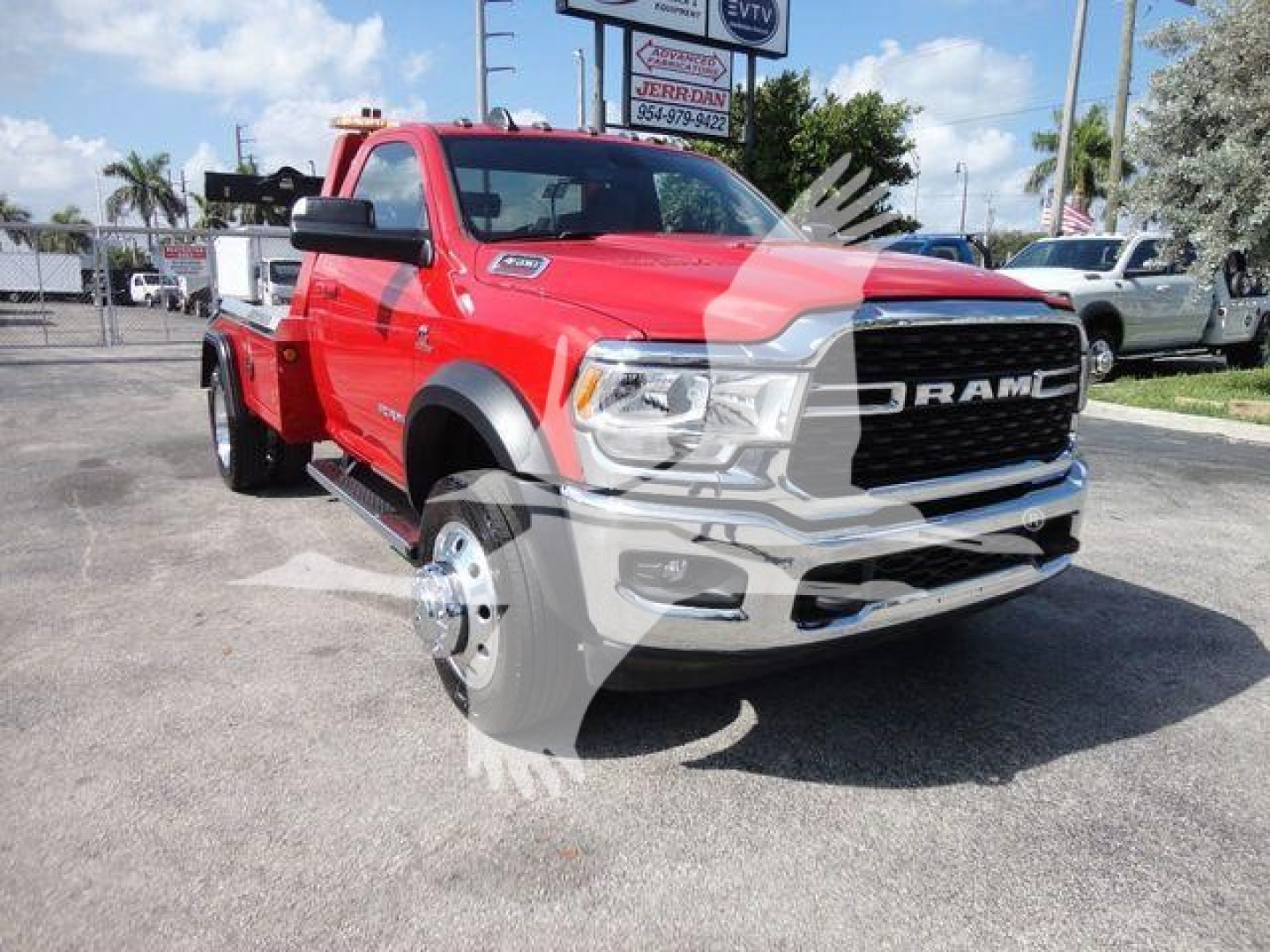 2024 Ram 4500 SLT red truck in a lot, front-right view with removed front wheel showing wheel hub; Ram grille and badge visible.