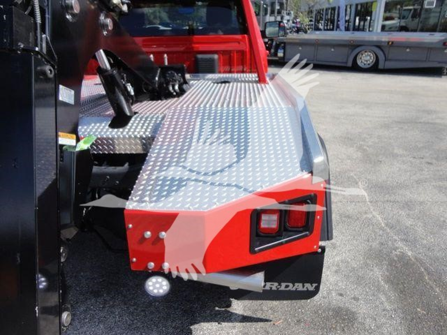 Ram 4500 SLT winch truck rear corner showing diamond plate steps and red bumper with tail light.
