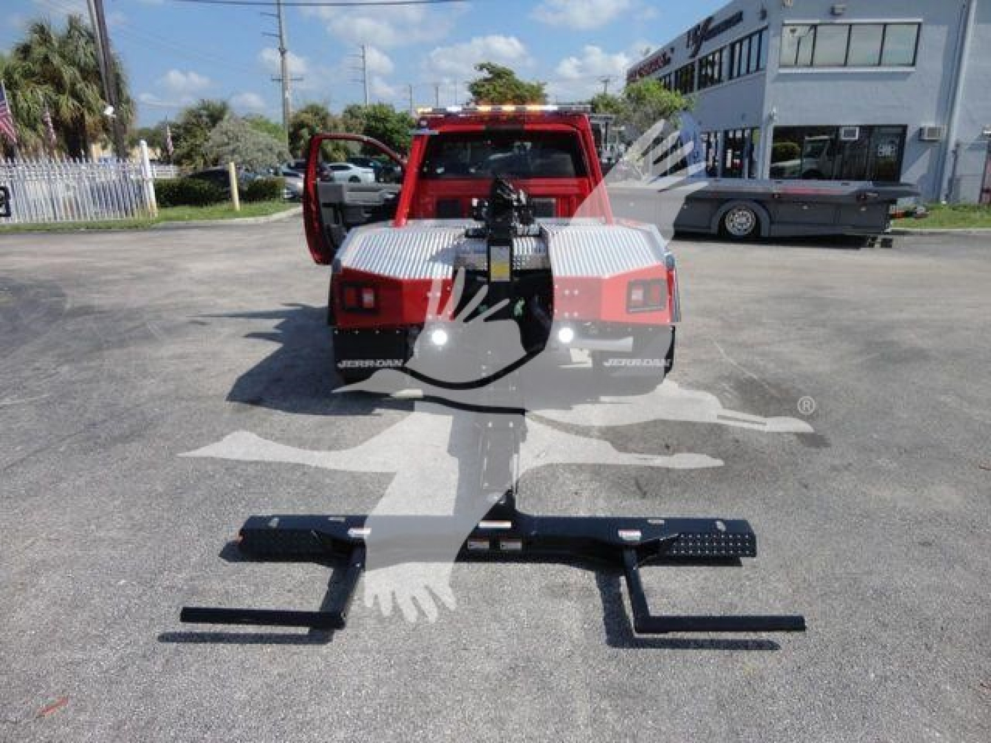 Ram 4500 SLT winch-equipped truck rear view showing mount, wiring, and winch assembly in a dealership lot.