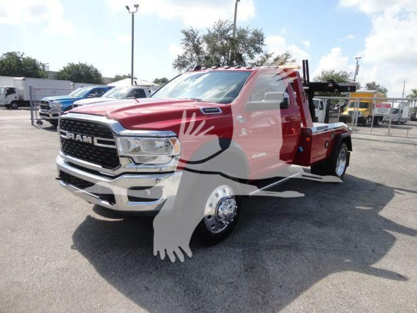 Ram 4500 tow truck/winch-ready chassis showing red exterior, large chrome grille, cab with dual mirrors, with winch equipment and flatbed in cargo area.