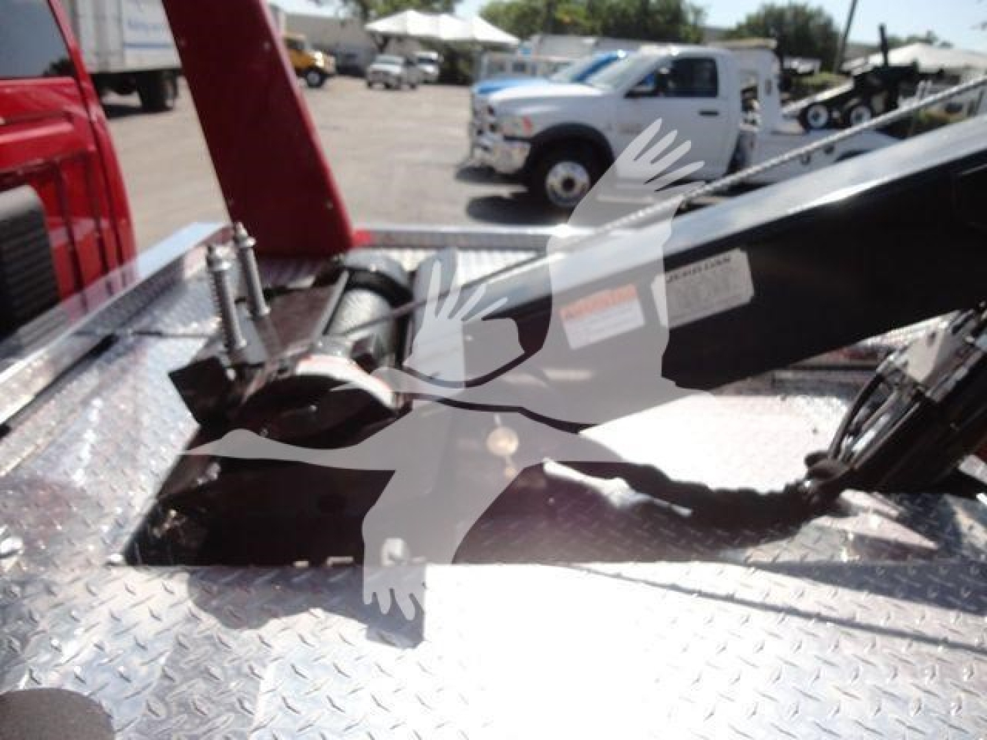 Winch-equipped Ram 4500 truck bed showing hydraulic winch mount and control wiring.