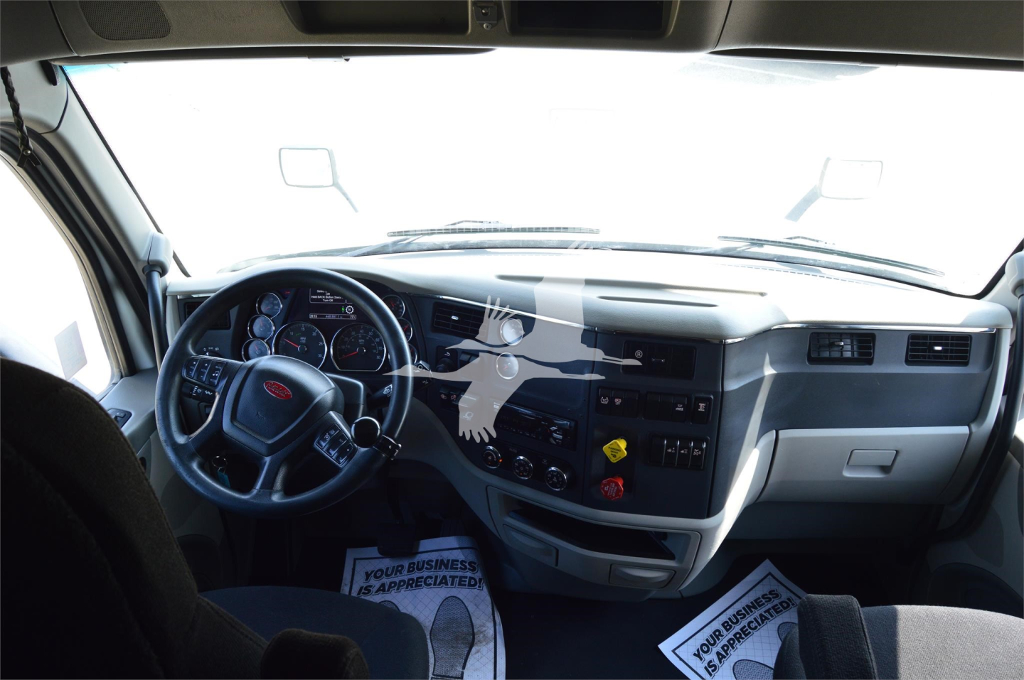 Peterbilt 579 dashboard and cab interior showing steering wheel, instrument cluster, and center console.