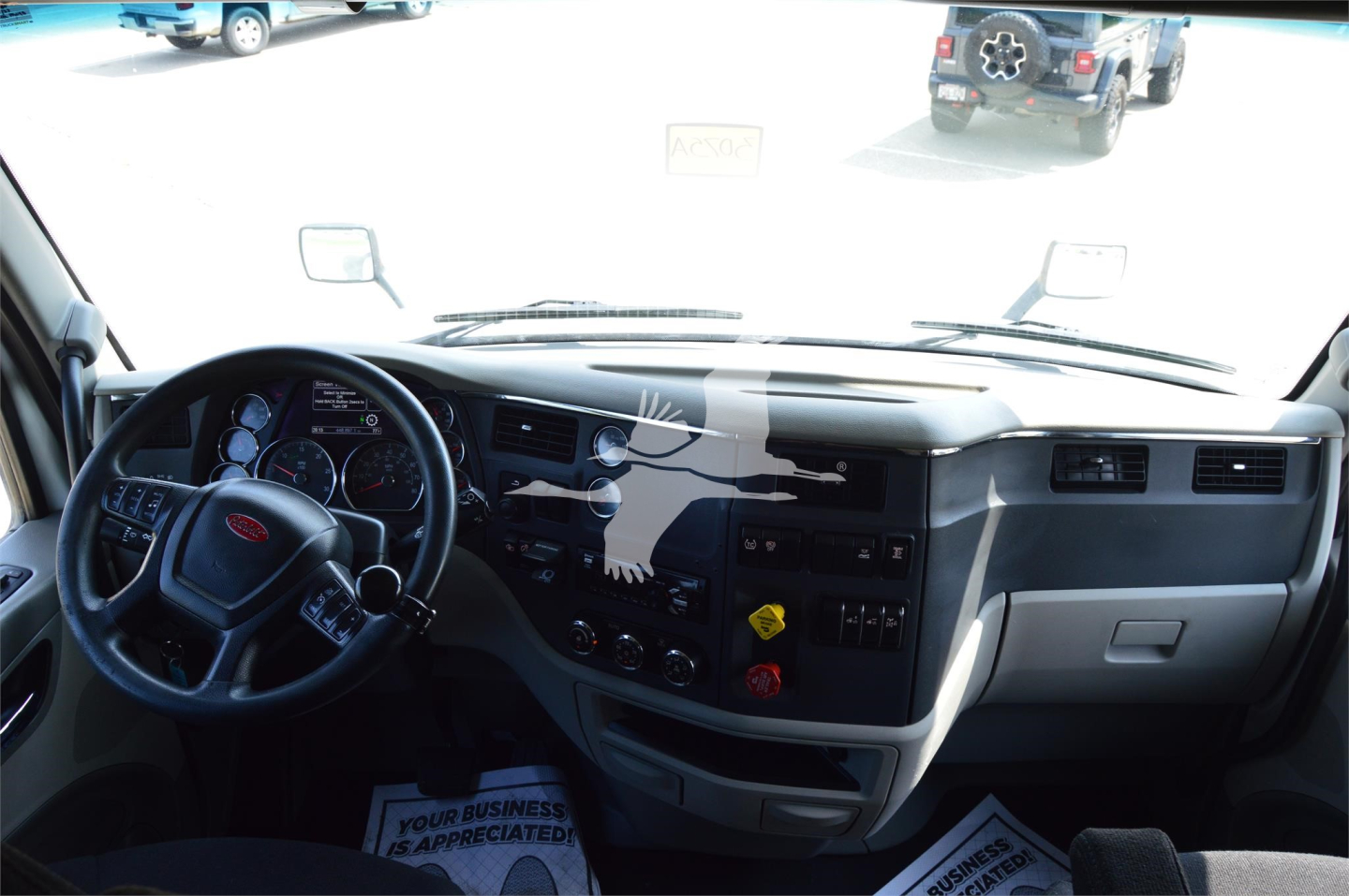 Peterbilt 579 cabin dashboard and steering wheel interior showing instrument cluster and center console.