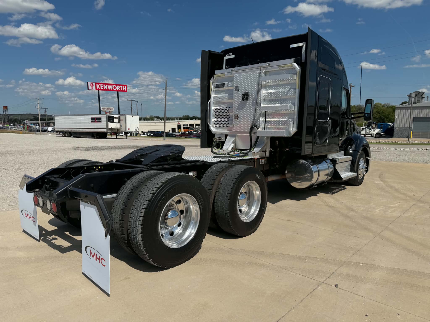 Kenworth T680 tractor rear and side showing sleeper cab, dual rear axles, and chrome fuel tanks.
