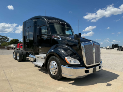 Kenworth T680 truck in black exterior profile view showing chrome front bumper and grille, Sleeper cab, two front axles, and rear dual wheels.