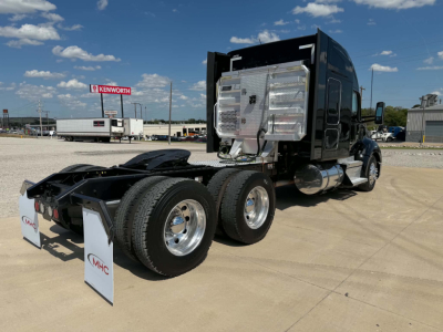 Kenworth T680 tractor rear and side showing sleeper cab, dual rear axles, and chrome fuel tanks.