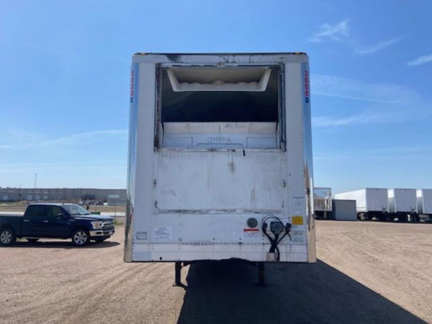 Refrigerated trailer rear view showing cooling unit and access doors on a 2017 Utility Reefer.