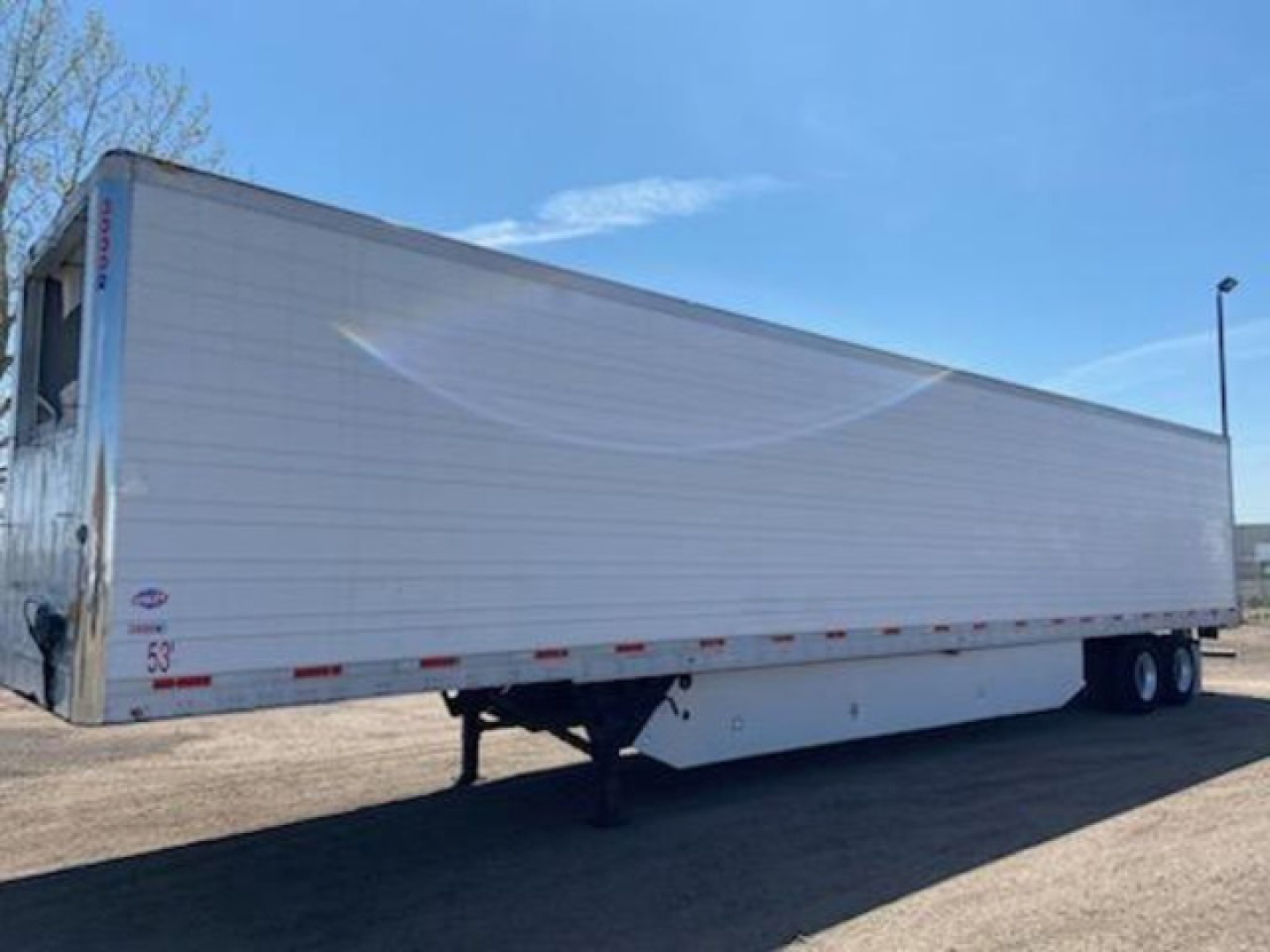 Trailer side view of a 2017 refrigerated utility trailer with white exterior, tandem axles, landing gear, and VIN label near front.