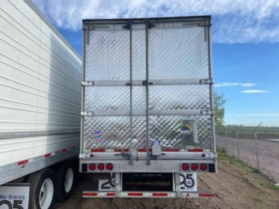 Rear view of a 2017 Utility Reefer trailer with diamond plate doors, rear lights, and bumper; visible stock number U90940 on tag; VIN 1UYVS2535H2997402 in listing.