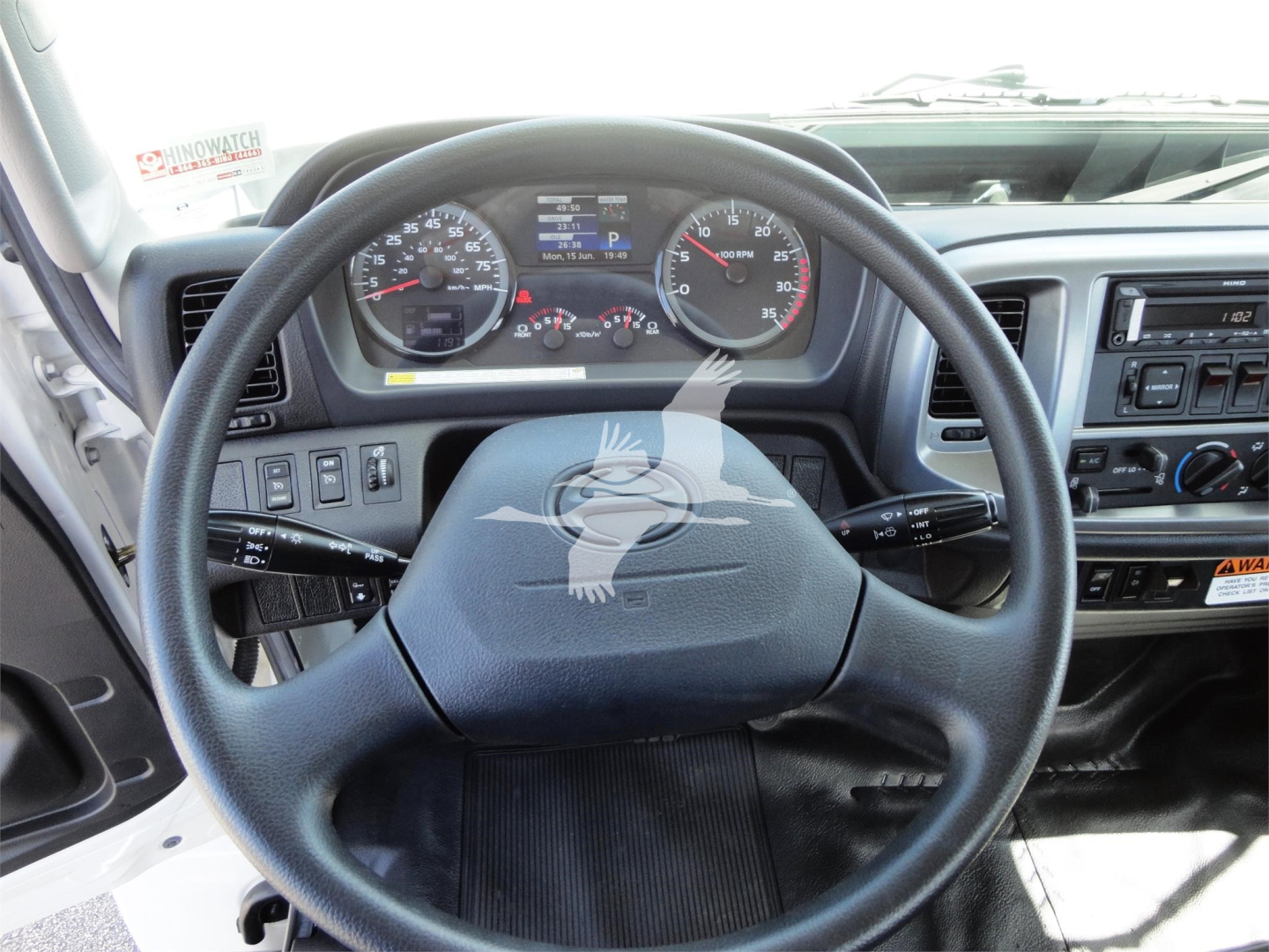 Truck cabin dashboard and steering wheel showing instrument cluster and controls