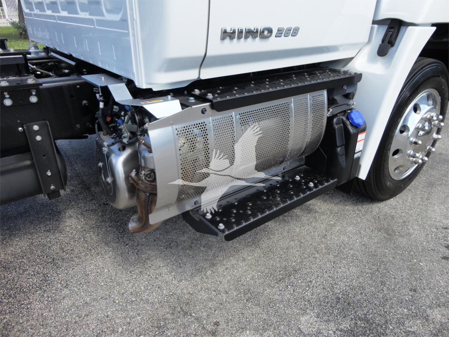 Hino 268A rollback truck side view showing fuel tank and side steps