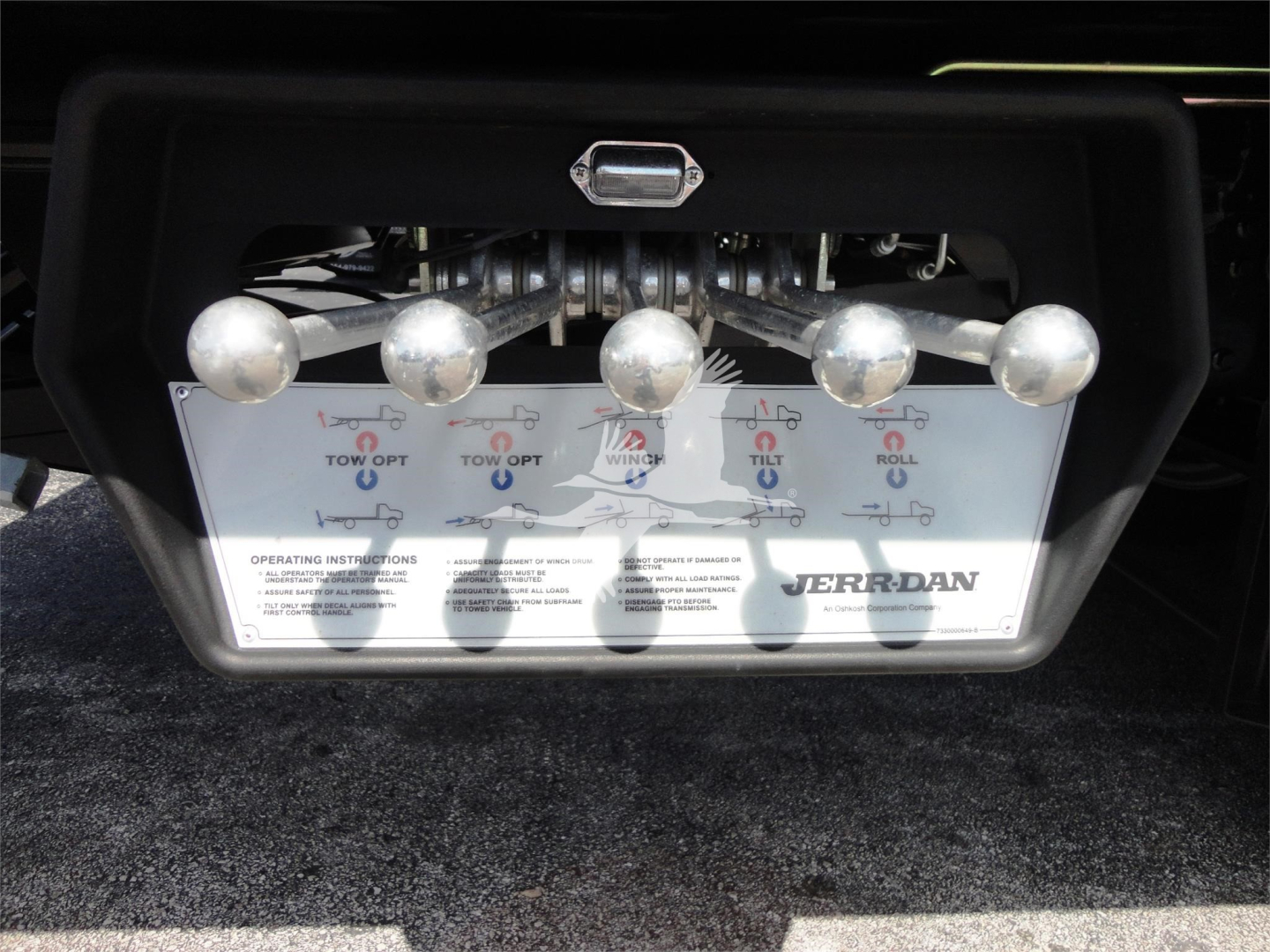 Hino 268A rear plate with multiple silver hooks and instruction panel showing TOW OPT, TOW O, ROLL, WJERR-DAN logo and operating instructions.