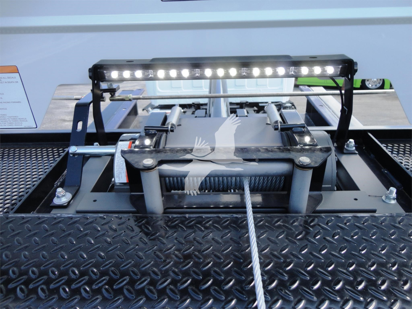 Trailer hitch mechanism with a LED light bar mounted on a metal platform, view from top.