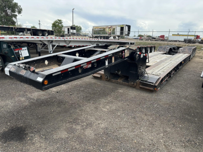 Load King RGn lowboy trailer in a used condition showing long flatbed sections and wheel bunks.