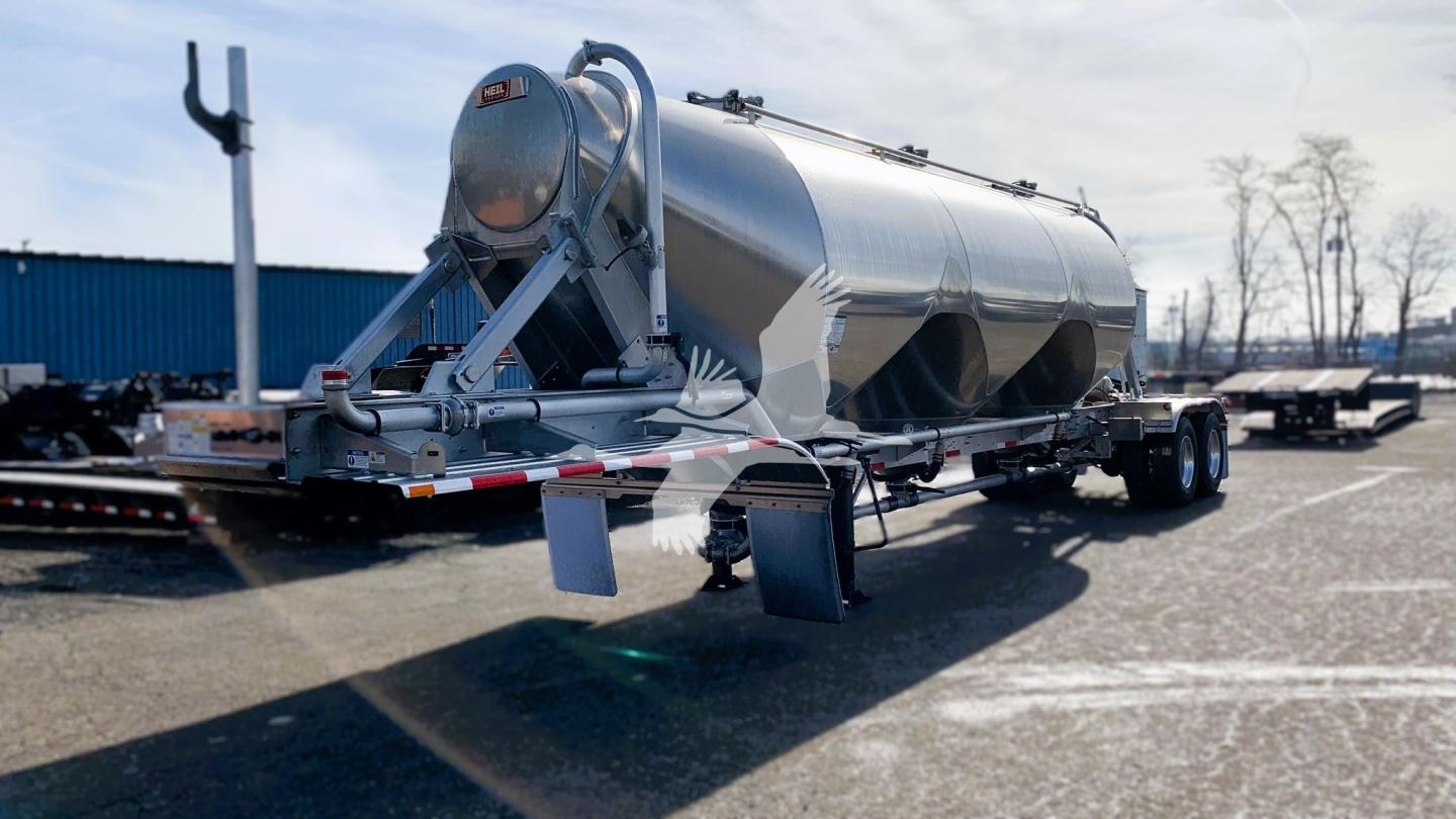  Heil Cementer trailer with cylindrical storage on dual-axle trailer, rear showing discharge chute and support legs. 
