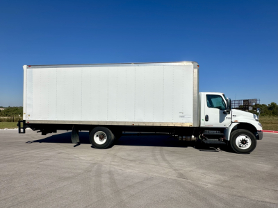 Box truck in service viewing left side with white cargo box and cab, International MV series, 2023 model year.