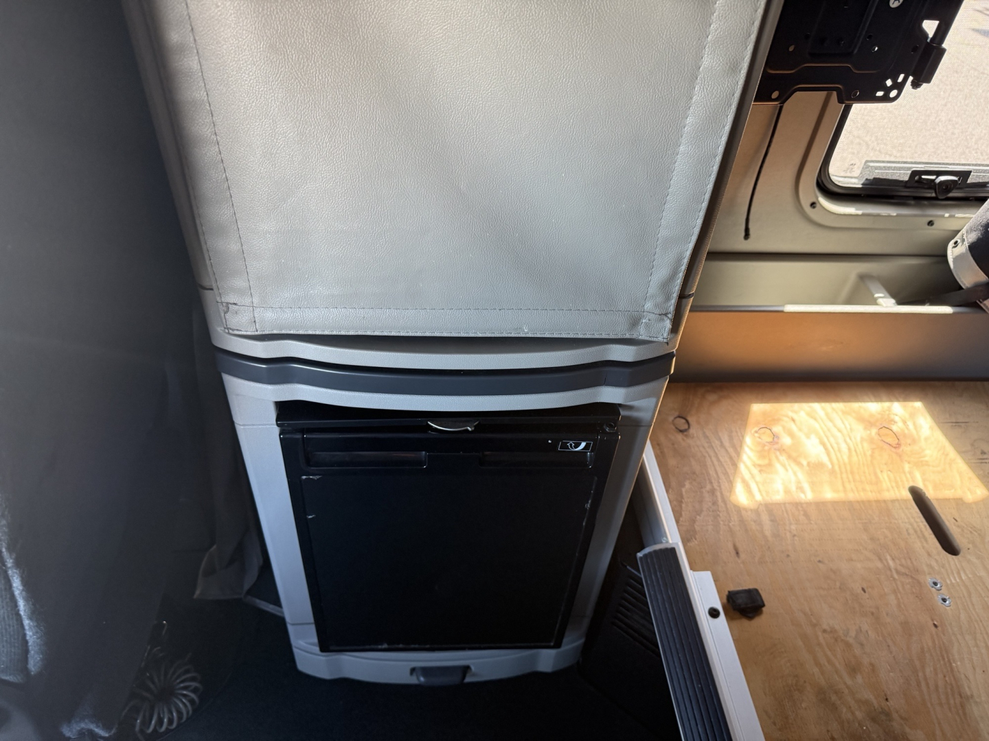 Peterbilt 579 cab interior with vertical luggage area and a black appliance panel near the floor; visible text shows stock and VIN information in listing context