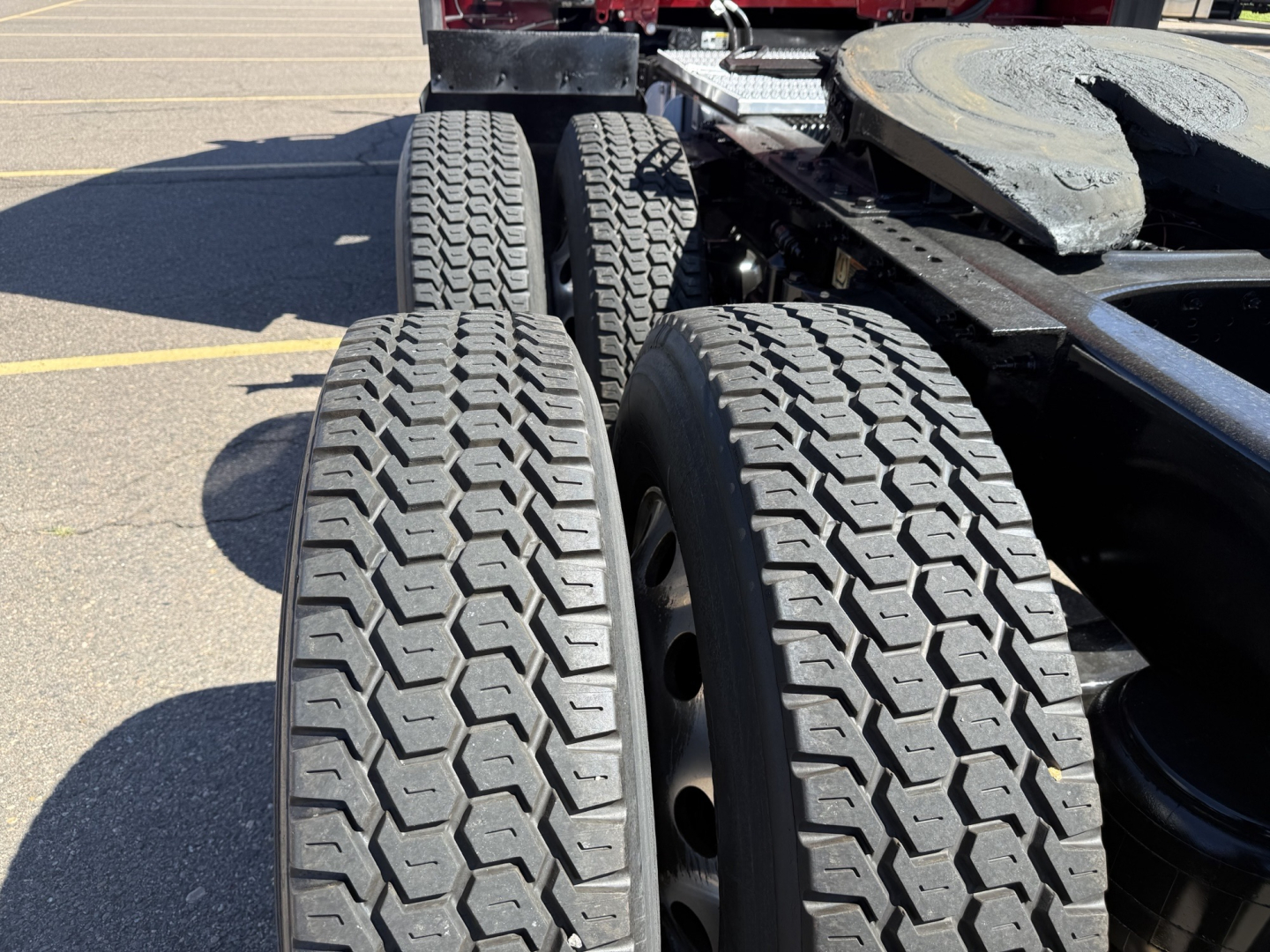 Peterbilt 579 truck chassis showing dual rear axles with heavy-duty tires and wheel rims.