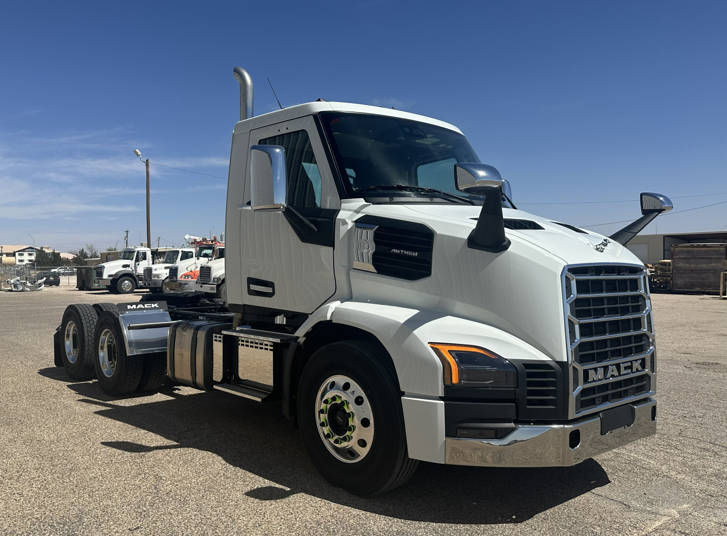Truck side view showing 2027 Mack AN64T conventional daycab with chrome grille and dual rear axles.