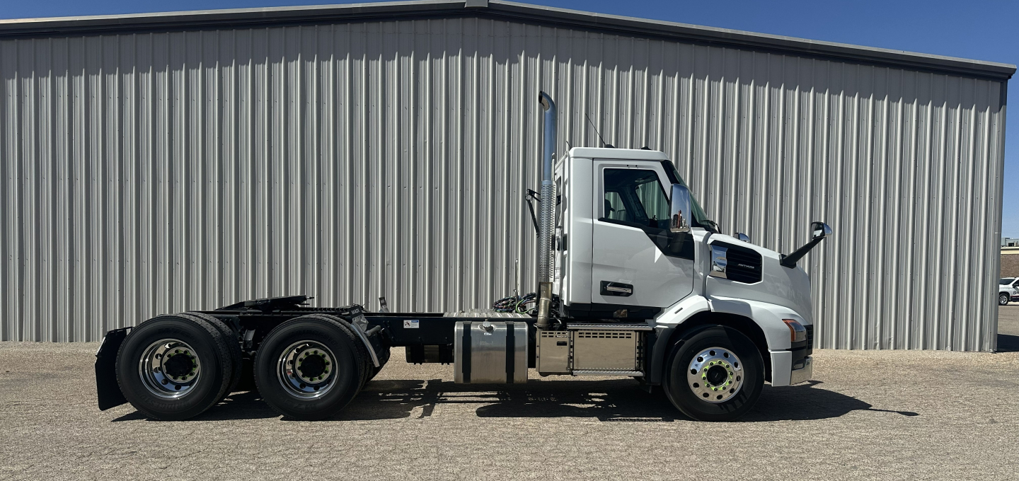 Mack AN64T daylight view showing truck chassis and cab from side with fuel tanks and wheels visible.