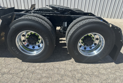 AN64T Mack truck rear dual wheels showing chrome wheels and Bridgestone tires, chassis frame visible, no cab in view.