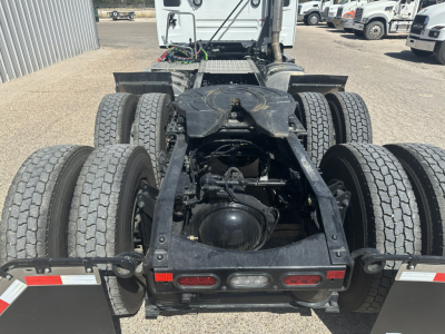 Truck chassis showing rear view of a Mack AN64T tractor with dual rear axles, multiple tires, and frame rails visible.