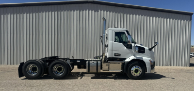 Mack AN64T daylight view showing truck chassis and cab from side with fuel tanks and wheels visible.