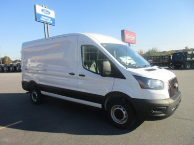  Ford Transit cargo van in a dealership lot showing side view with white body and black front bumper.