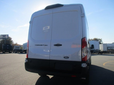 Ford Transit Cargo Van rear view showing back doors and rear lights, white exterior, small rear badge, in a dealership lot.